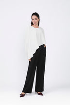 Asymmetrical Paris coat with decorative pearl button at the back.