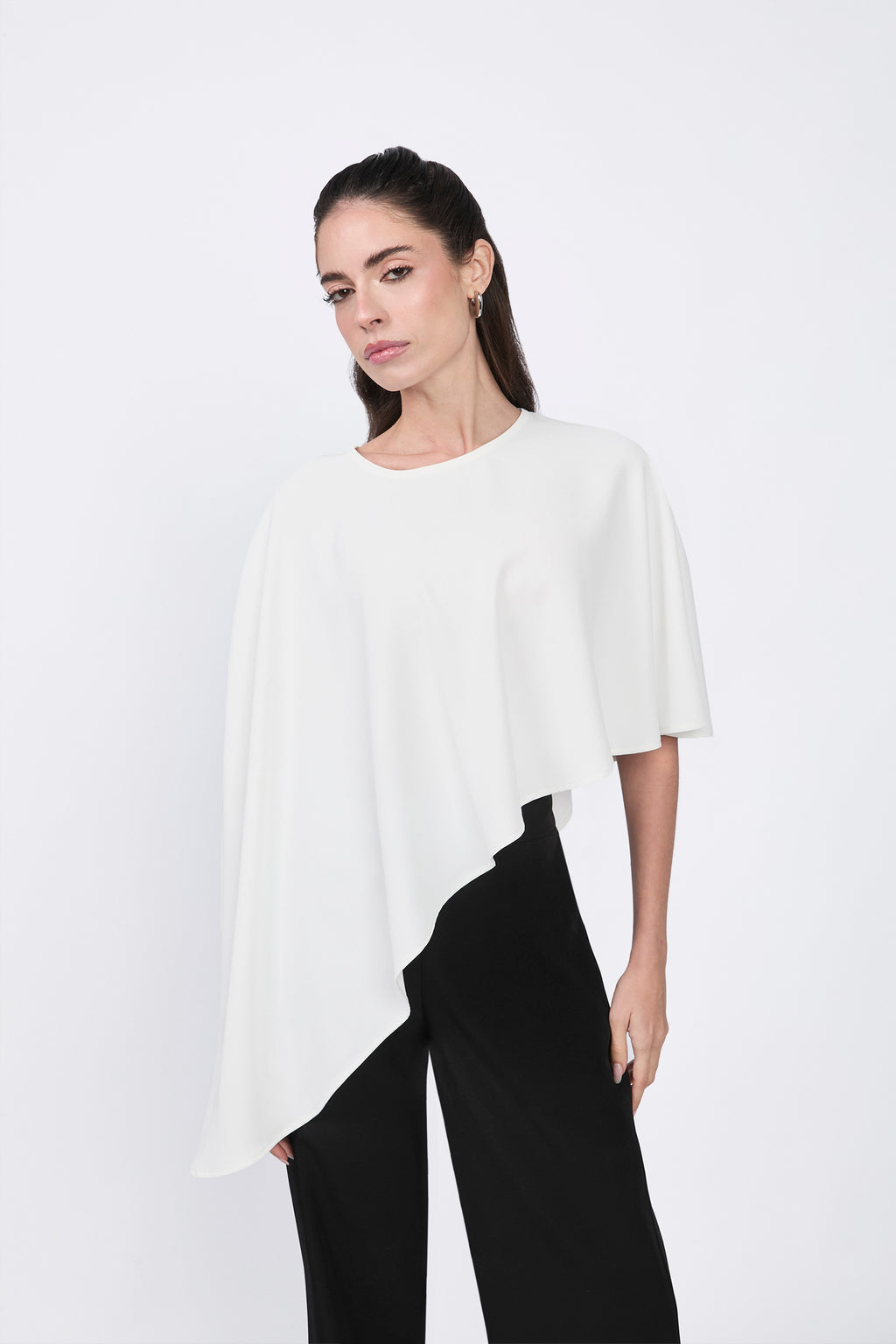 Asymmetrical Paris coat with decorative pearl button at the back.