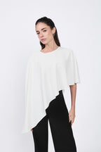 Asymmetrical Paris coat with decorative pearl button at the back.